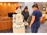 Two nurses collect medical supplies from a drawer on a robot assistant at Lancaster General Health.